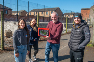 Pictured demonstrating the new app is Paul Smyth from Belfast Interface Project (centre) alongside Caitriona O'Neill, Eimear Kelly and Kevin Barry Brown from the Star Neighbourhood Centre.