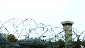 A view of barbed wire and a prison watchtower | NI CRC