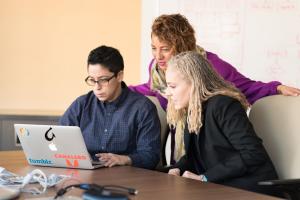 Three people learning around a laptop | CRC NI