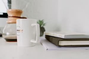 a coffee mug and books | CRC NI