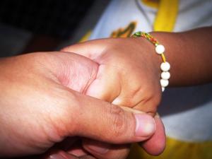 An old person holding hands with a child | CRC NI