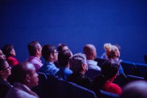 People seated watching a lecture | NI CRC