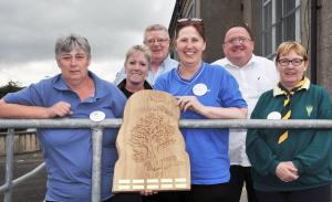 Several people standing with the commemorative trophy | CRC NI