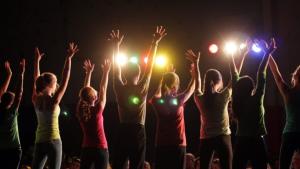A crowd of people with their hands raised | CRC NI