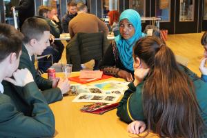 People sitting around a table in discussion | CRC NI