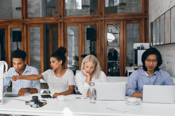 People working together at separate laptops | NICRC